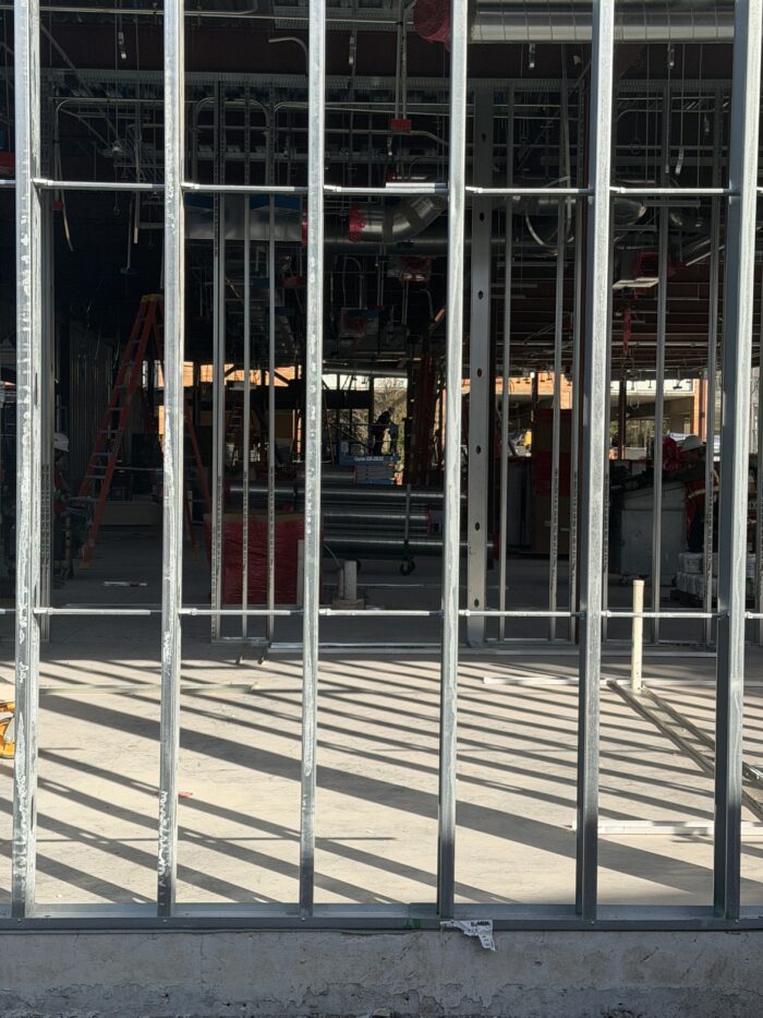 Workers continue framing and sheathing for the new building