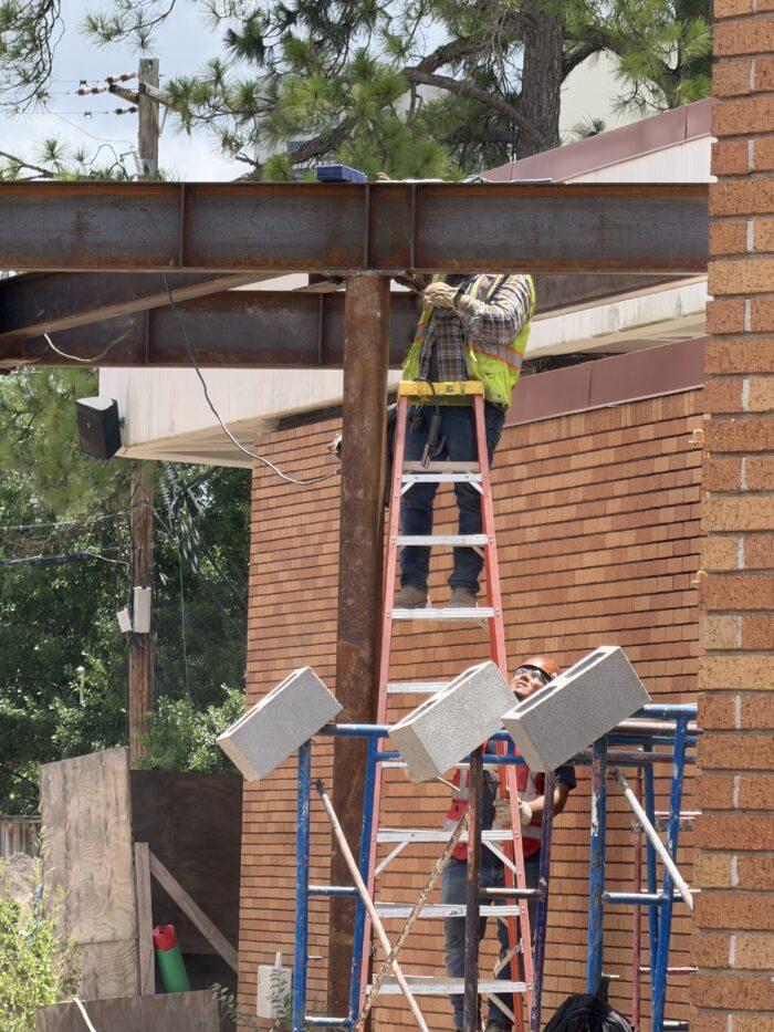 Workers welding steel on the connection to the North Lobby