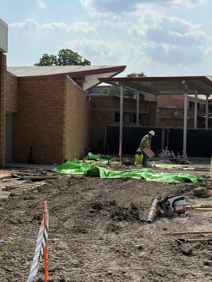 Workers creating the grade beams that will help support the building