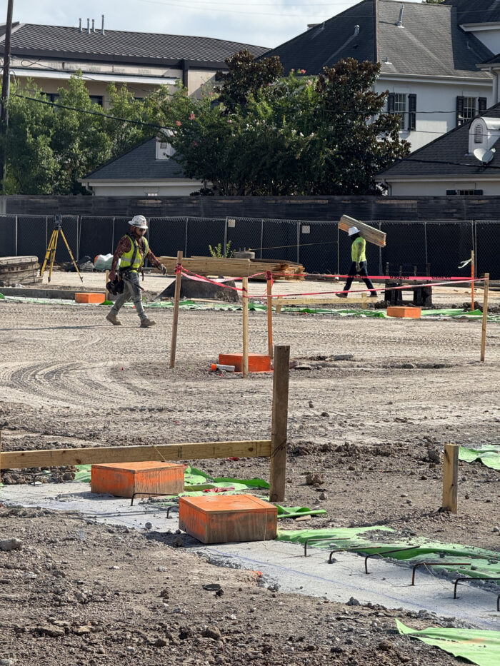 Workers completing grade beams and prep for elevator pit