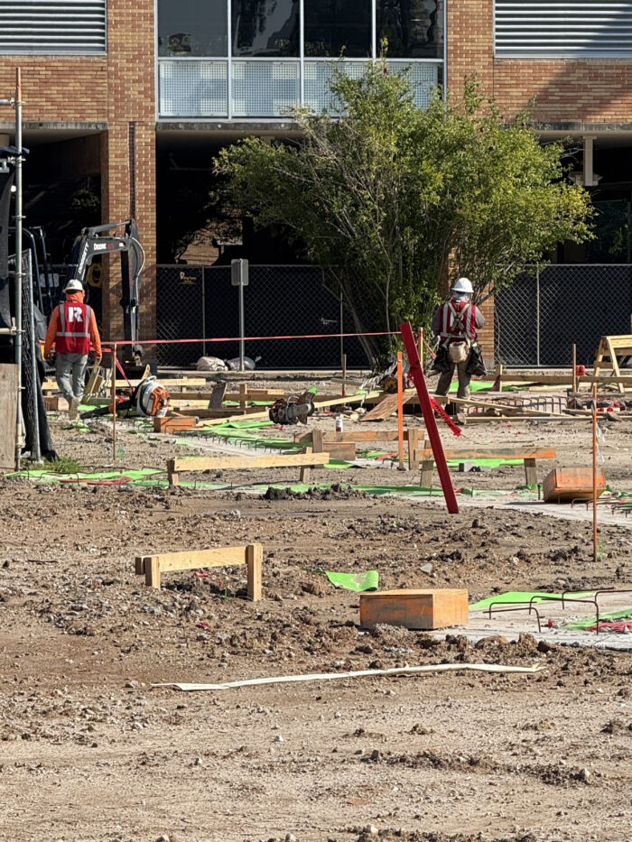 Construction crew working on underground MEPs (mechanical, electrical, and plumping)
