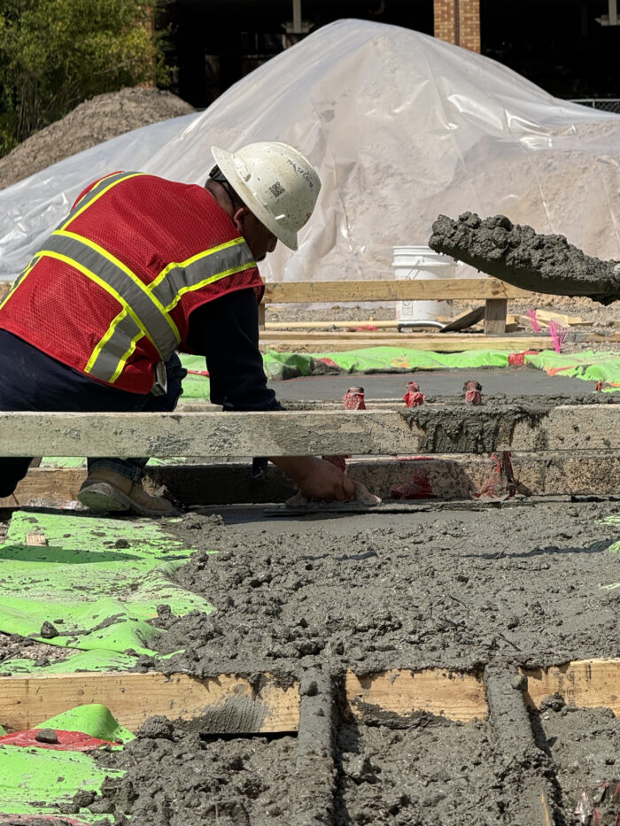 Construction workers use rebar and concrete to create grade beams to support the weight of the exterior walls