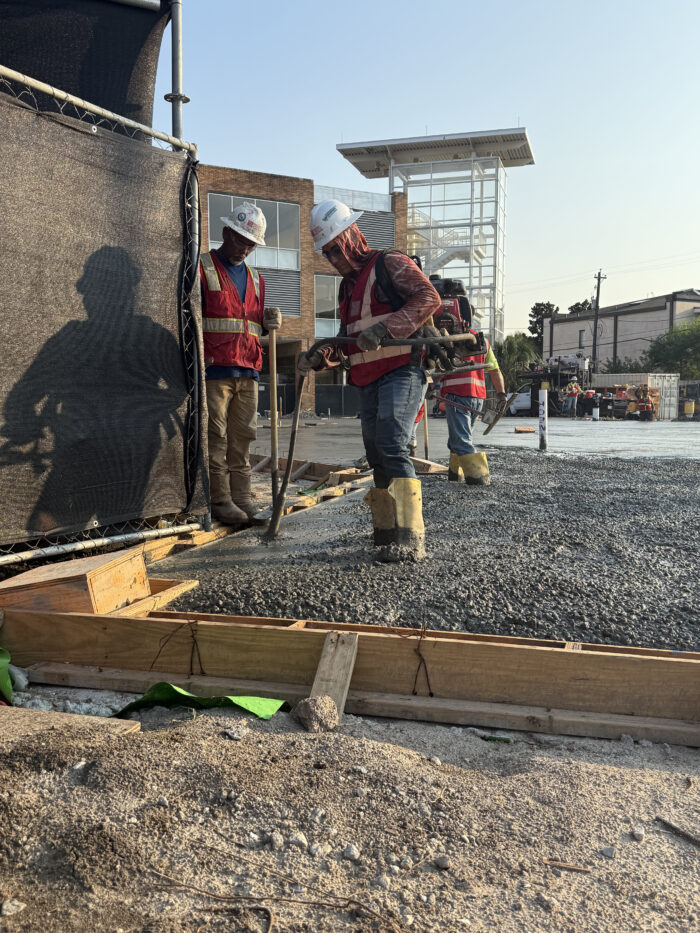 Construction crews pouring the foundation for the new building.